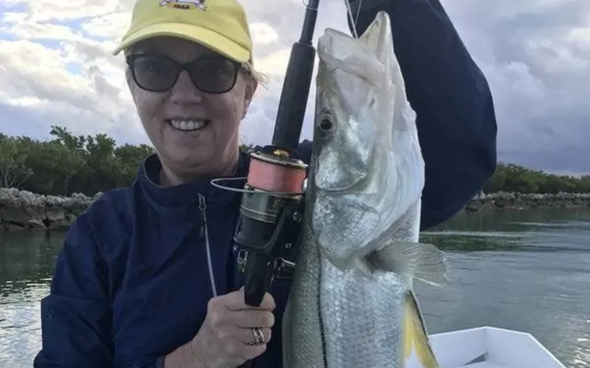 Angler holding a snook caught on an inshore charter near Fort Lauderdale, FL - Nomad Fishing Charters