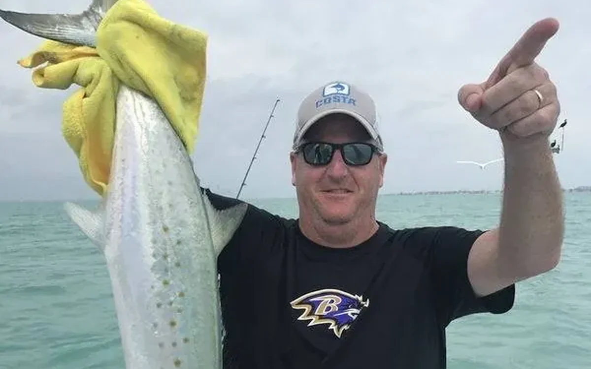 Angler holding a fish caught on a half day charter near Fort Lauderdale, FL - Nomad Fishing Charters