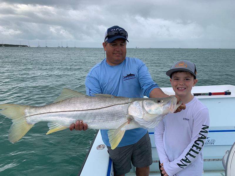 Angler holding tarpon and snook on Fort Lauderdale inshore fishing charter
